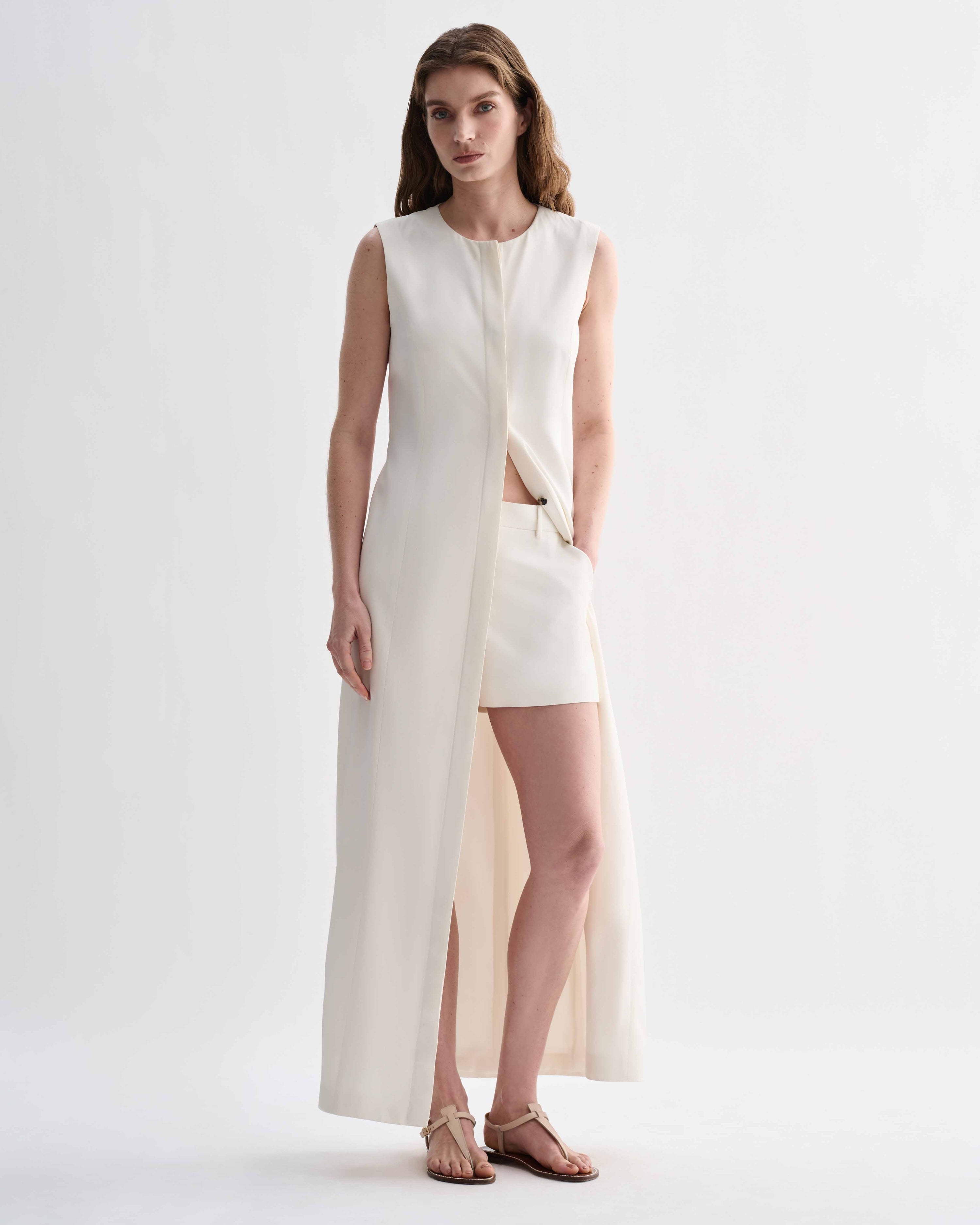 Off-white silk Hana dress by Veronica De Piante, flowing design with elegant neckline and smooth fabric details.