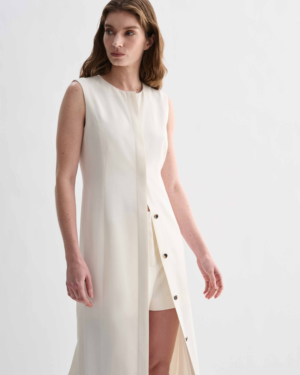 Off-white Hana Silk Dress by Veronica De Piante, featuring elegant fabric and flowing design, displayed on a hanger.