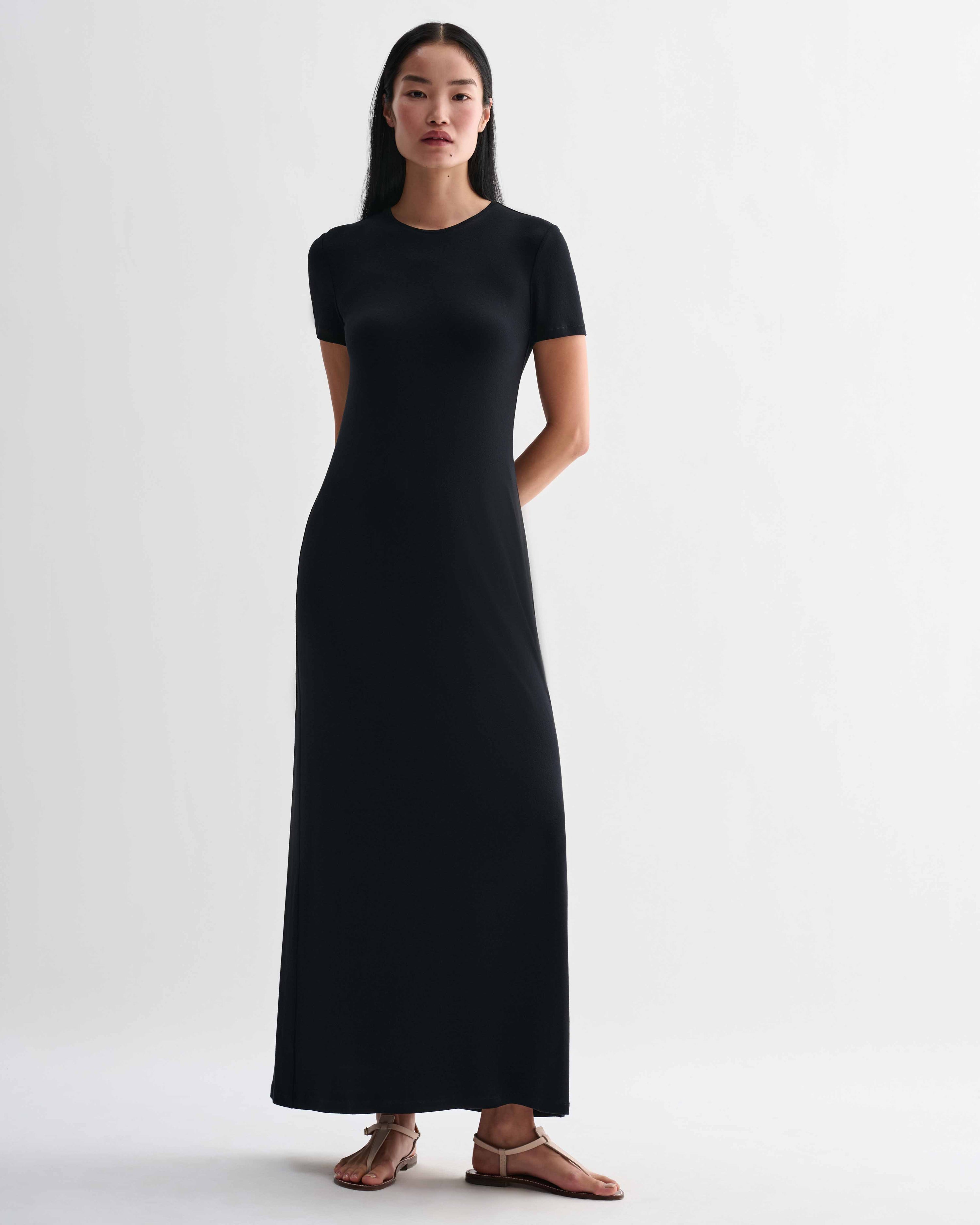 Black Veronica De Piante Harper dress made from stretch viscose jersey, shown on a hanger with a simple background.
