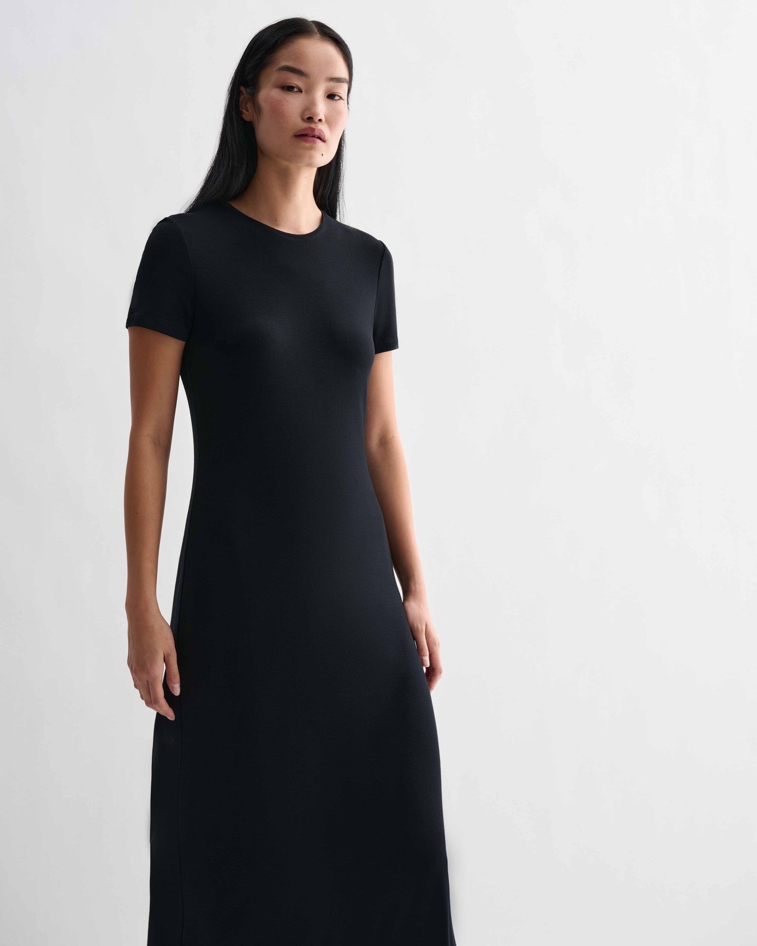 Black Harper dress in stretch viscose jersey by Veronica De Piante, shown on a model with a fitted silhouette and elegant design.