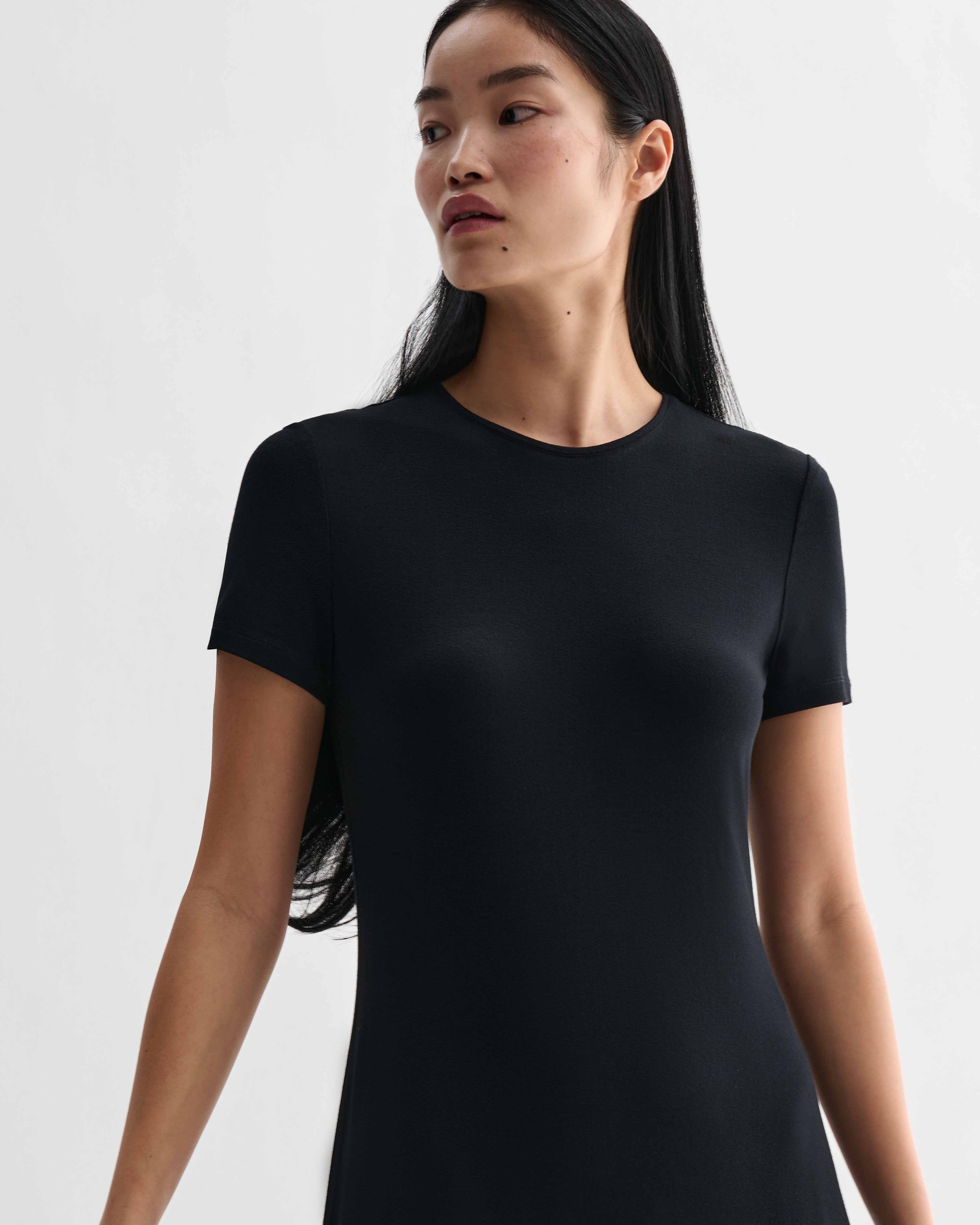 Black Harper dress by Veronica De Piante in stretch viscose jersey, shown on a model with a fitted silhouette and elegant neckline.