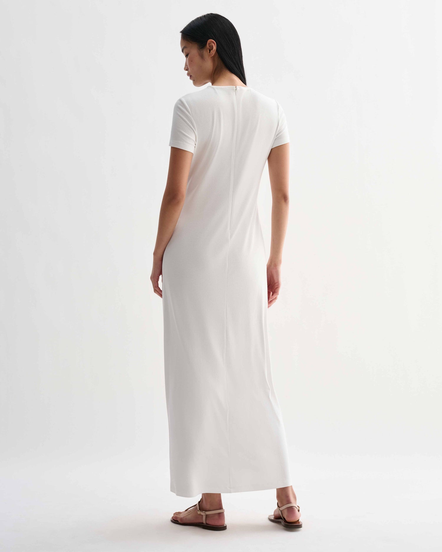 Off-white Harper dress in stretch viscose jersey by Veronica De Piante, shown on a hanger with a close-up of fabric texture.
