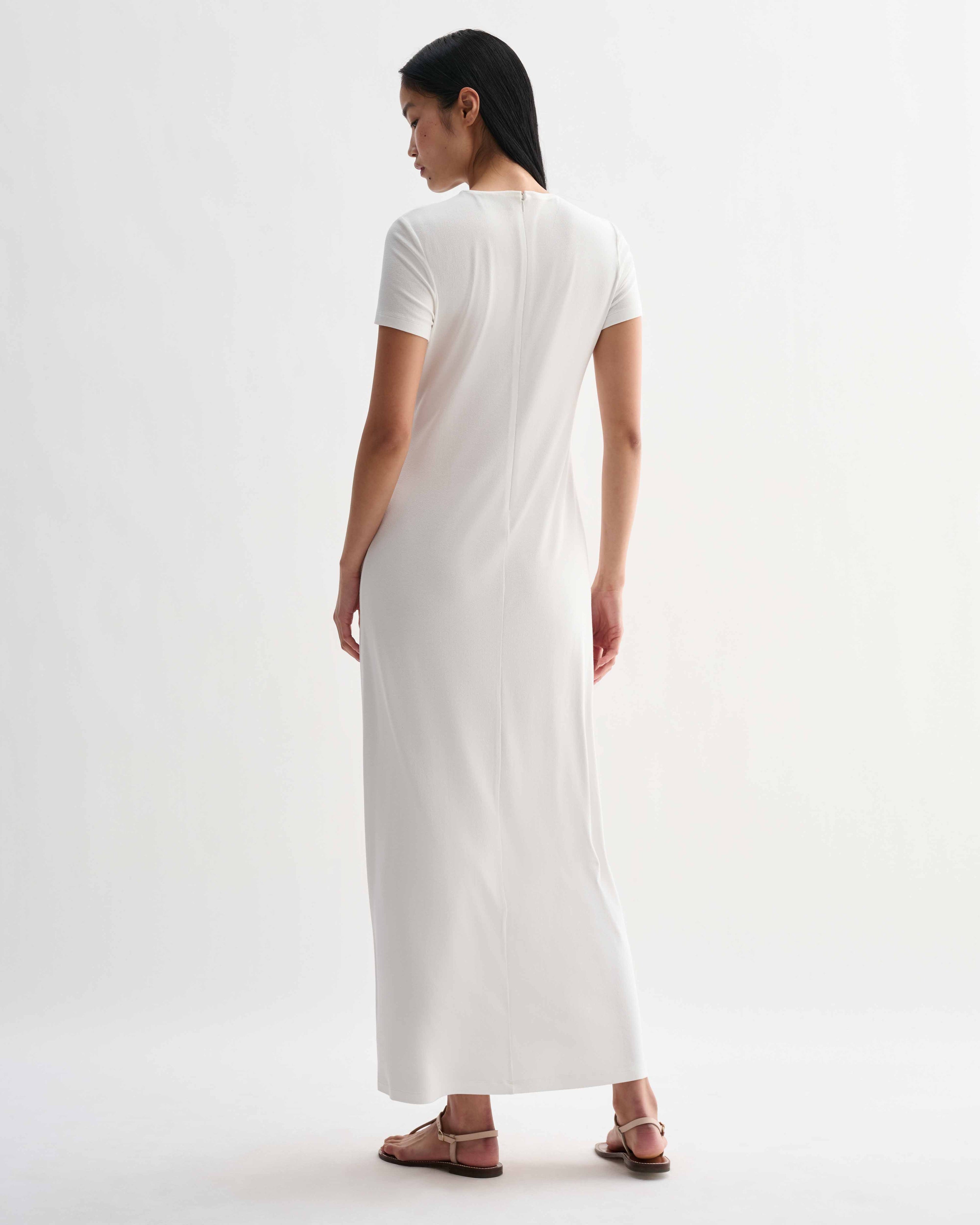 Off-white Harper dress in stretch viscose jersey by Veronica De Piante, shown on a hanger with a close-up of fabric texture.