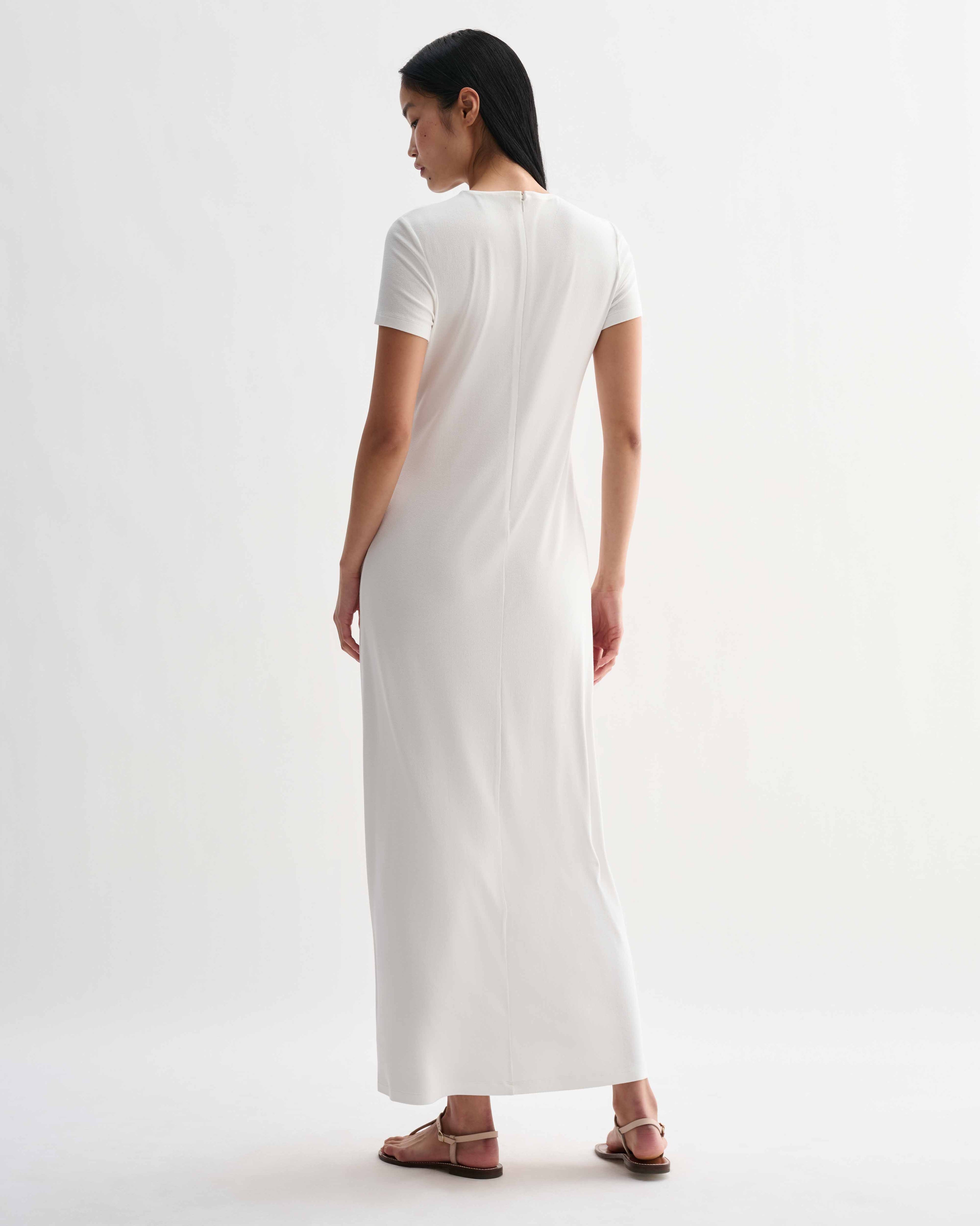 Off-white Harper dress in stretch viscose jersey by Veronica De Piante, shown on a hanger with a close-up of fabric texture.