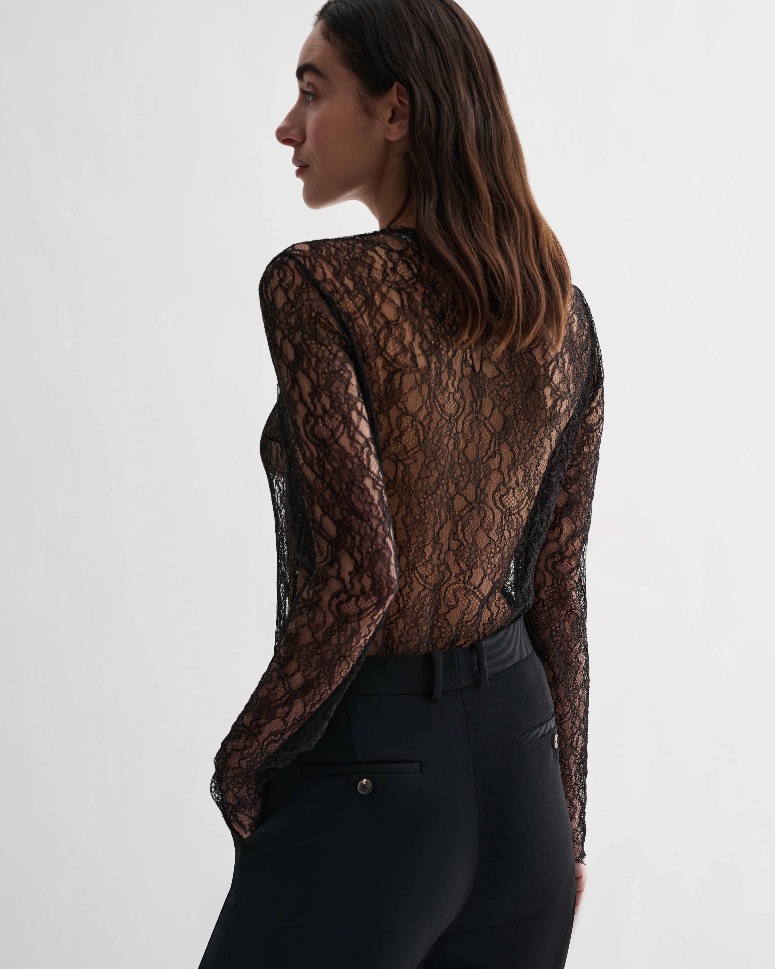 Black lace Isabel top by Veronica De Piante, featuring delicate lace fabric and a fitted style, displayed on a mannequin.