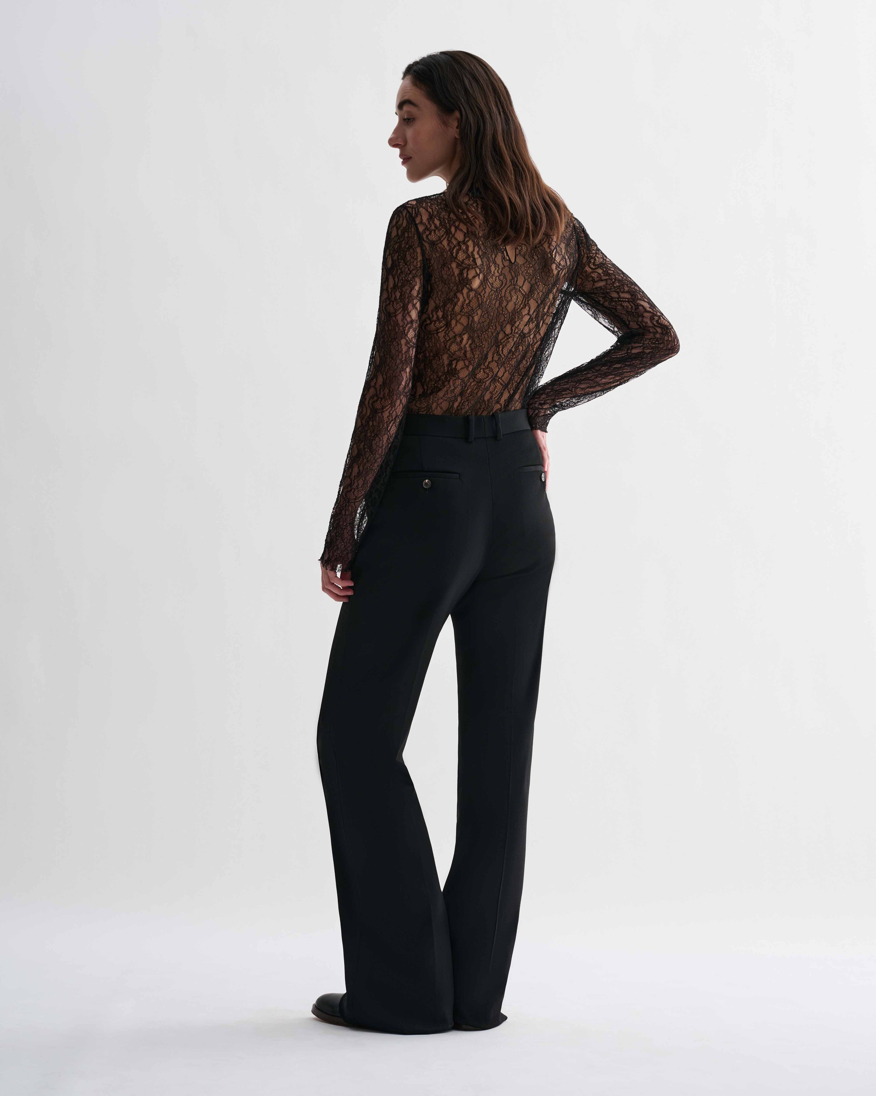 Black lace Isabel top by Veronica De Piante, shown on a model with intricate lace details and a stylish, fitted design.