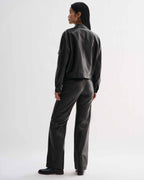 Veronica De Piante Juno Nappa Leather Black jacket displayed on a hanger, showcasing sleek design and smooth leather texture.
