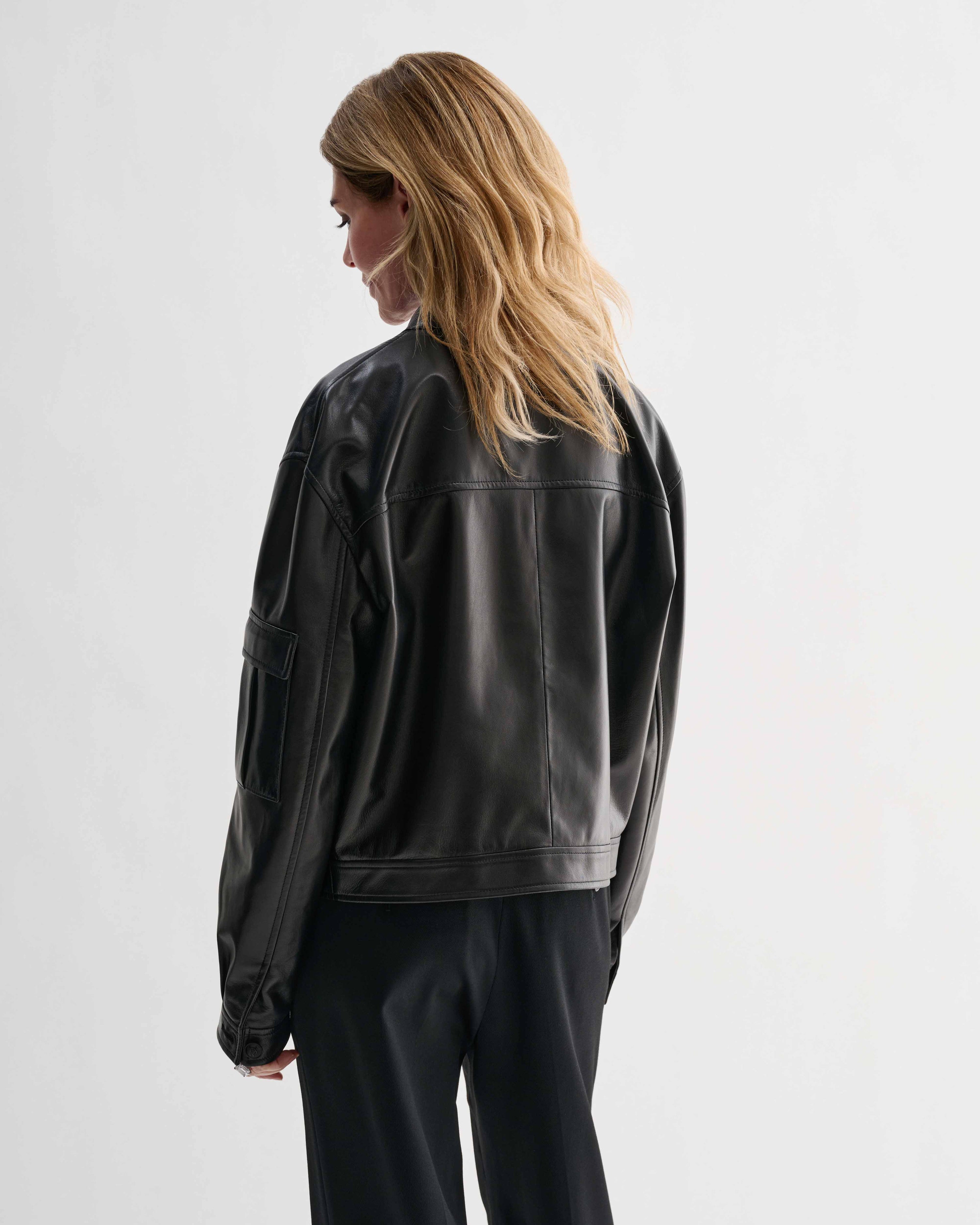 Veronica De Piante Juno black nappa leather jacket with sleek design, shown hanging on a hanger.