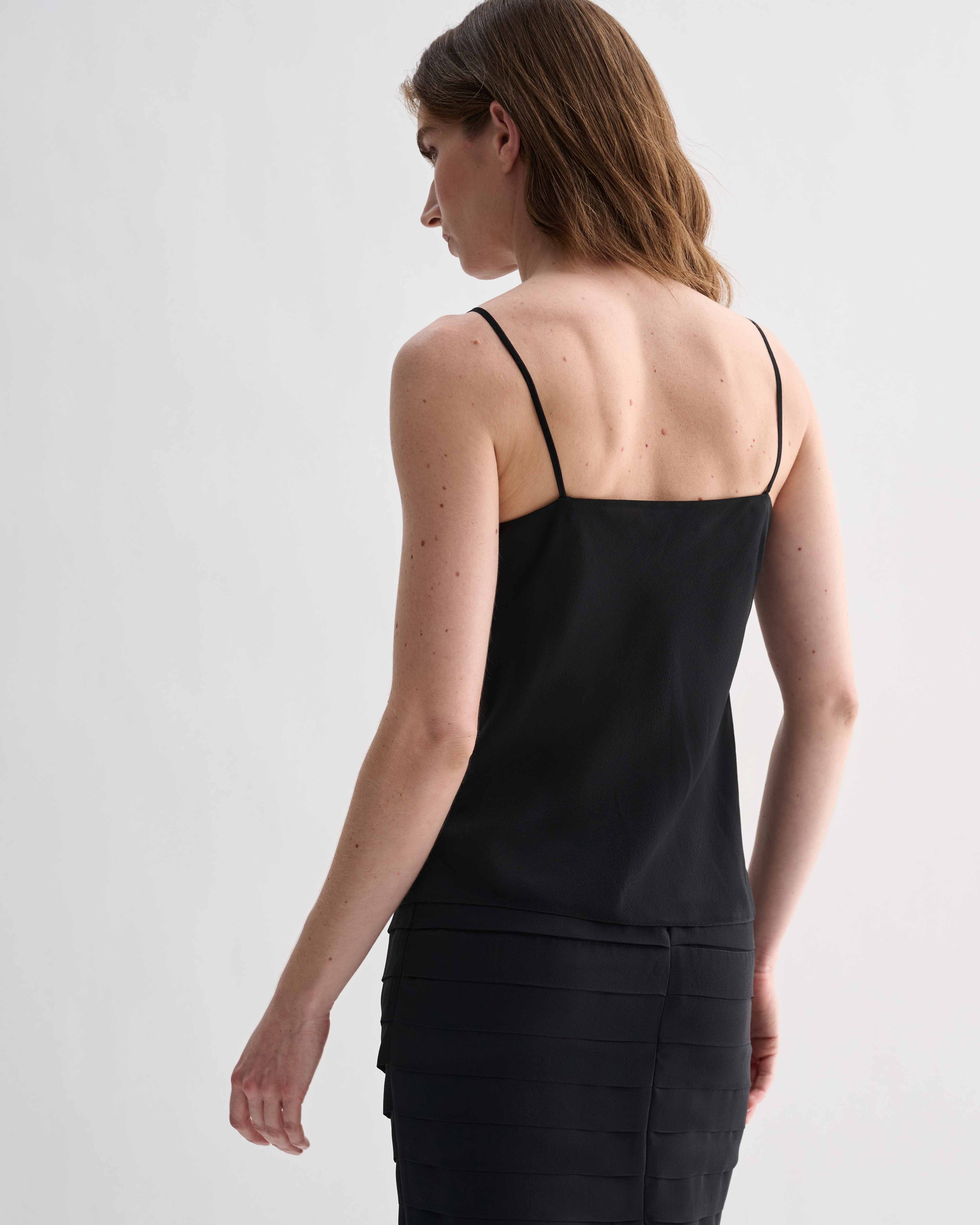 Black Lina Camisole in Georgette by Veronica De Piante, featuring delicate straps and flowing fabric, styled as a stylish women’s top.