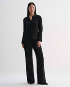 Black Livia linen shirt by Veronica De Piante, shown on a hanger with a relaxed fit and natural fabric texture.