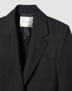 Black Faye Wool Jacket by Veronica de Piante, stylish coat with a tailored fit and classic design, displayed on a hanger.