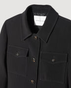 Black Alma jacket in viscose crepe by Veronica De Piante, showcasing its sleek coat design and textured fabric.
