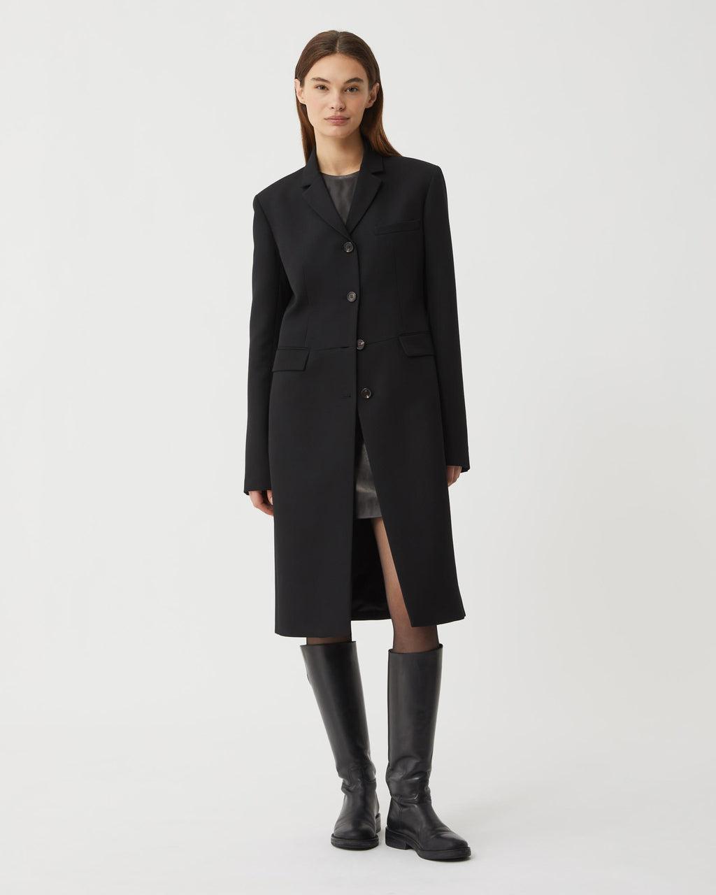 Black wool Manon coat by Veronica De Piante displayed on a hanger, showcasing its tailored design and elegant silhouette.