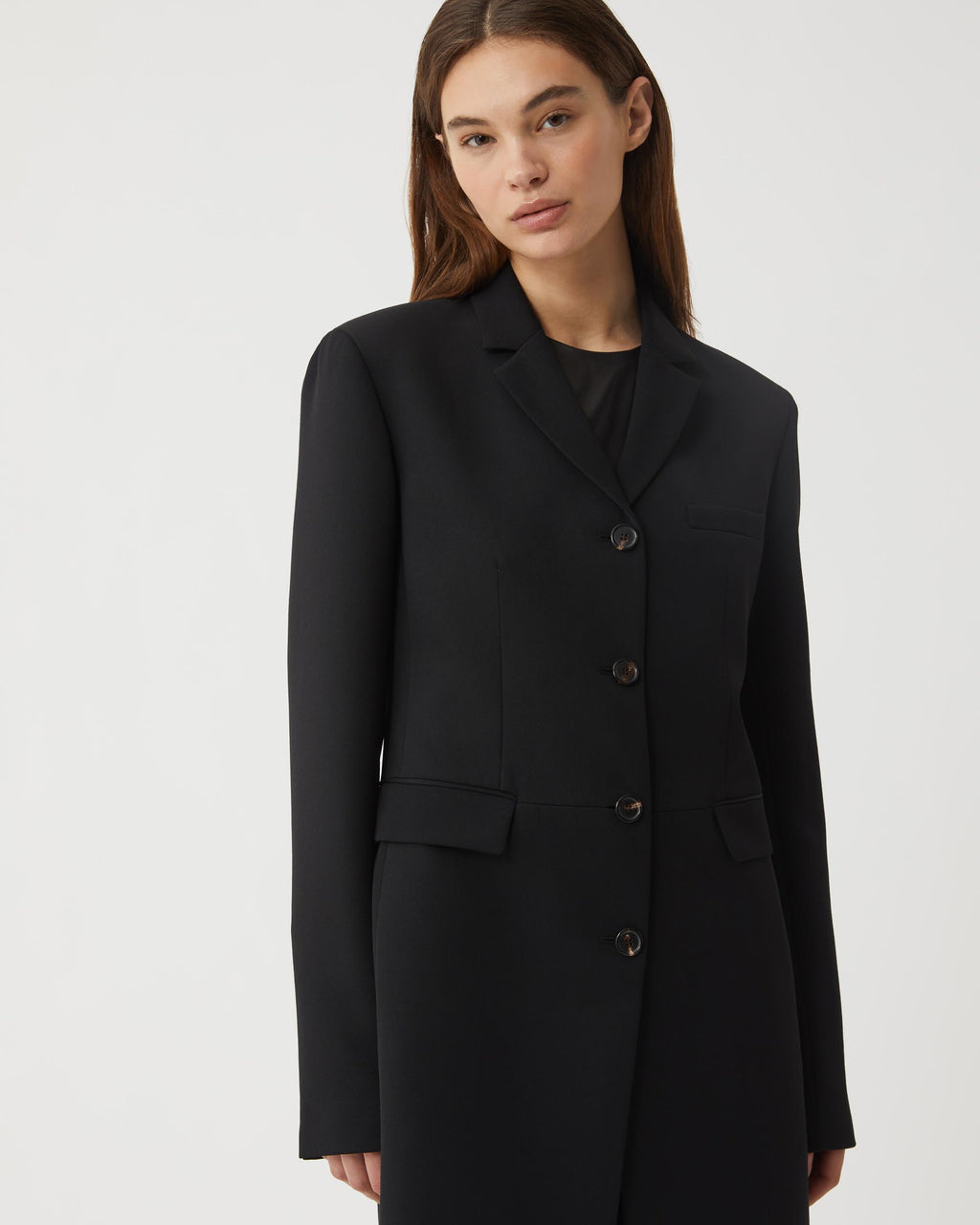 Black wool Manon coat by Veronica De Piante, featuring a classic design and tailored fit, displayed on a mannequin.
