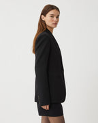 Black Faye Wool Jacket by Veronica de Piante, shown hanging with a tailored fit and classic collar, ideal for stylish winter wear.