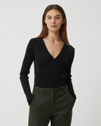 Black Ada Polo knitwear by Veronica de Piante, made from viscose, displayed on a hanger with close-up fabric texture.