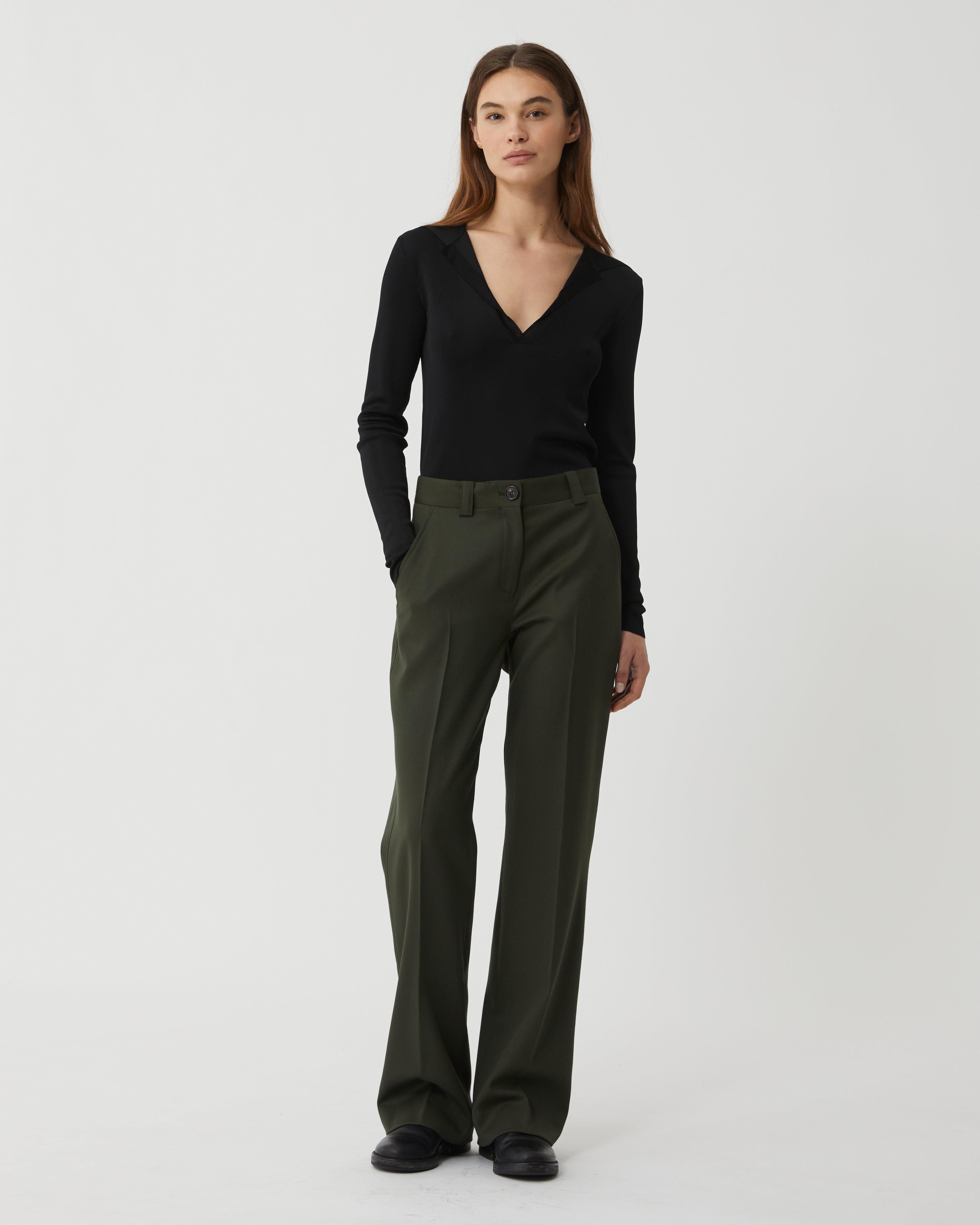 Black Ada Polo knitwear by Veronica de Piante, made from viscose, featuring a classic collar and smooth fabric texture.