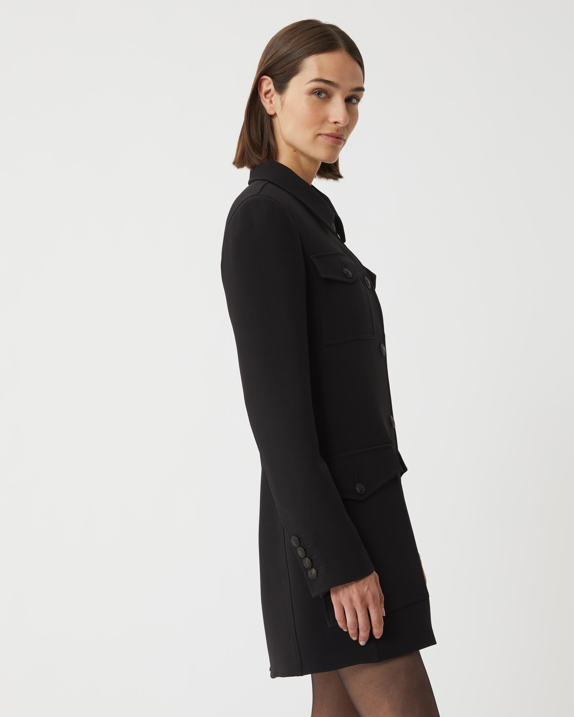 Black Alma jacket in viscose crepe by Veronica De Piante, shown on a hanger with a structured coat design.