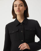 Black Alma jacket in viscose crepe by Veronica De Piante, shown on a hanger with a sleek, tailored design.