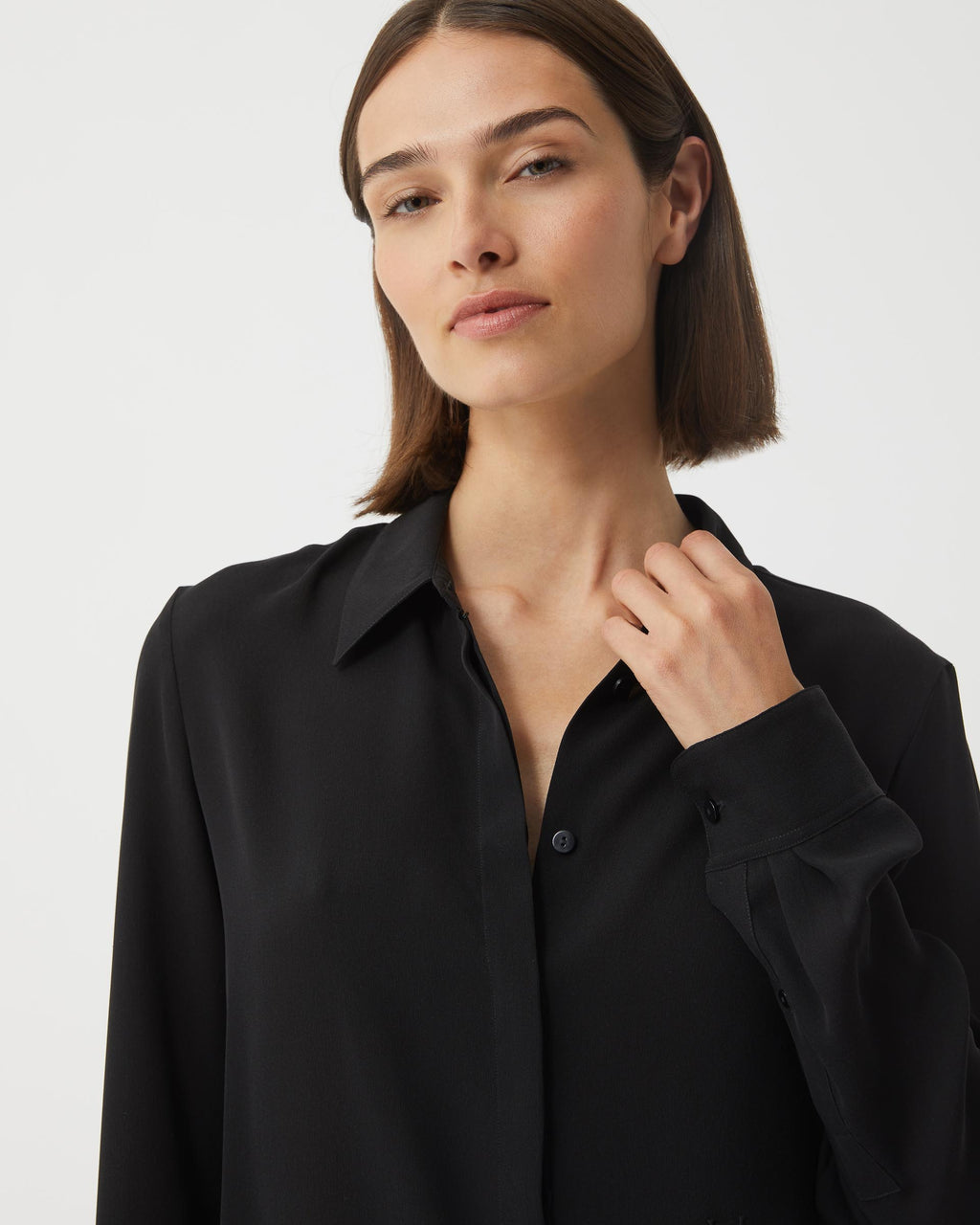 Black silk georgette Camille shirt from SALE, featuring a flowing design and elegant neckline, displayed on a hanger.