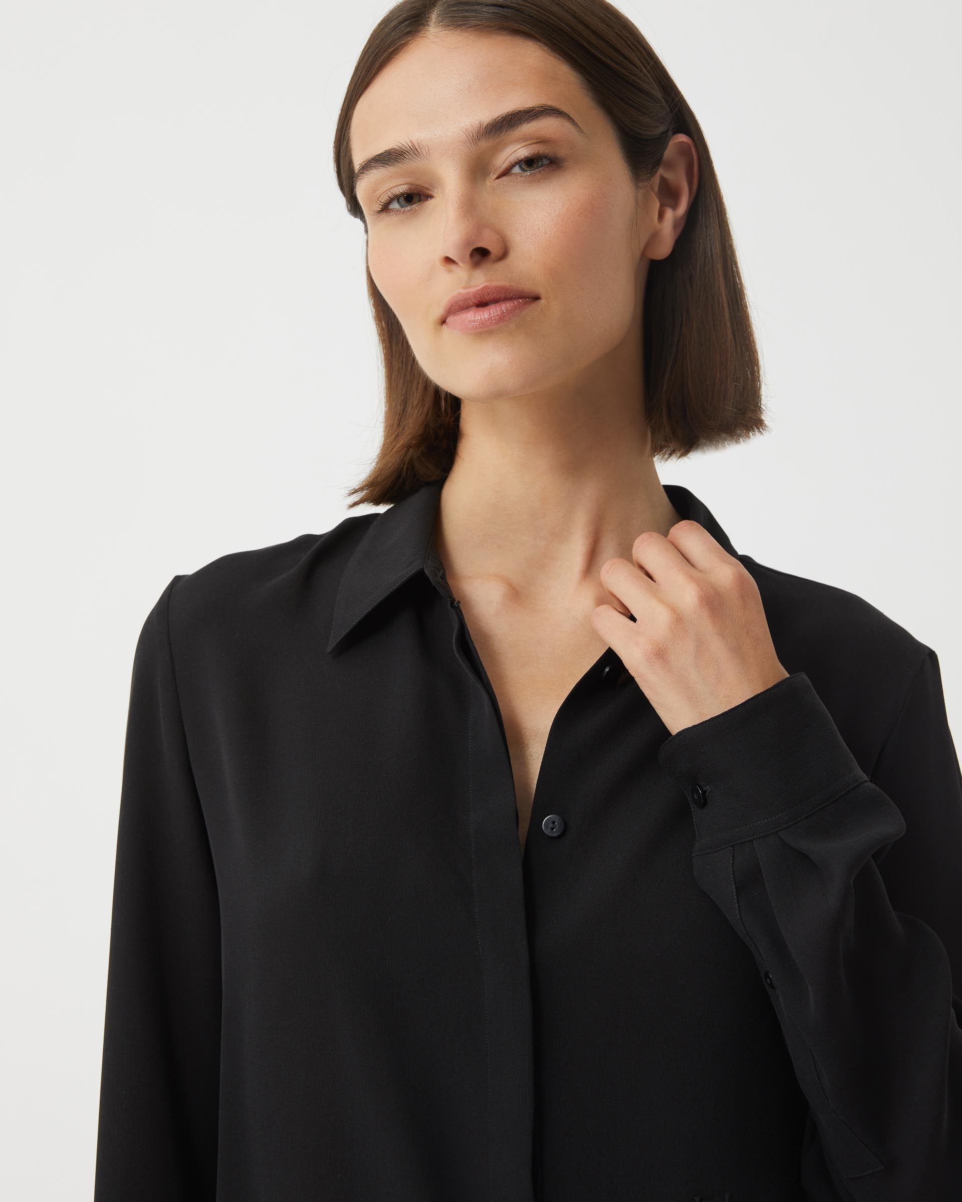 Black silk georgette Camille shirt from SALE, featuring a flowing design and elegant neckline, displayed on a hanger.