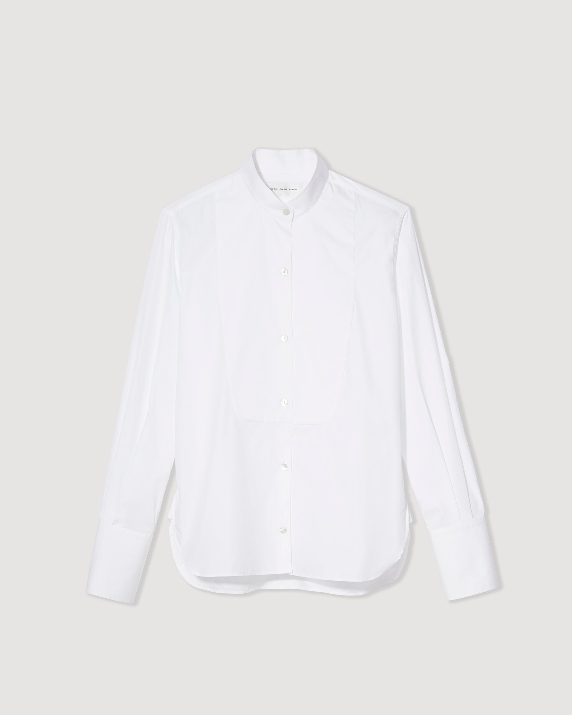 White cotton poplin tuxedo shirt by Veronica De Piante displayed on a flat surface, showcasing its sleek design.