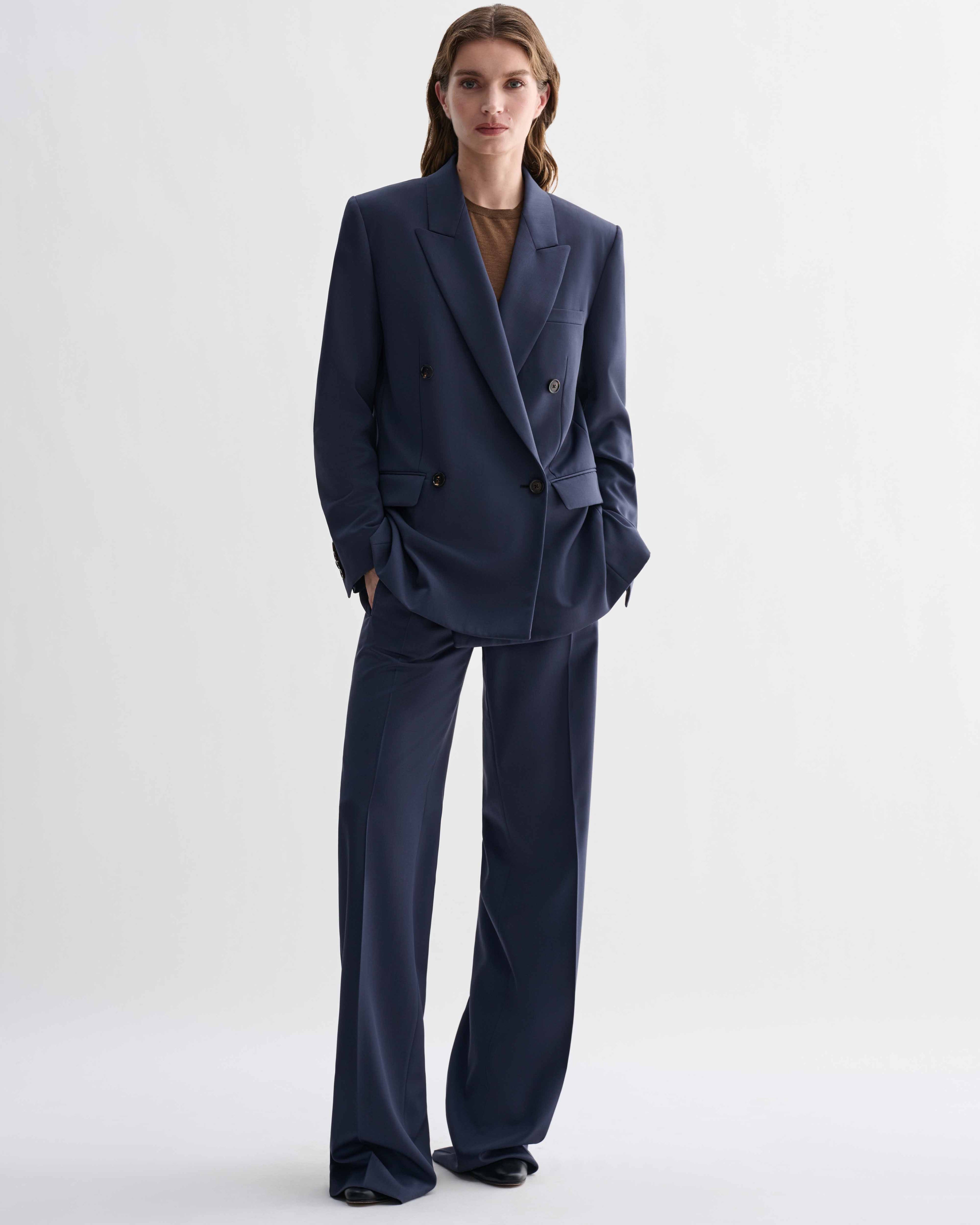 Roman Double Breasted Jacket in Petrol Blue wool and matching wide-leg Dylan trousers. A precise, menswear-tailored suit