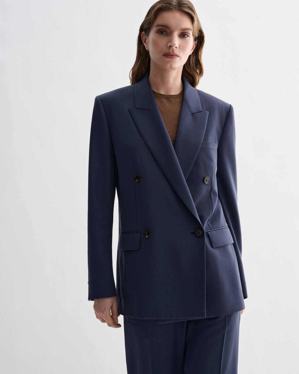 Roman Double Breasted Jacket in Petrol Blue pure wool. Menswear-tailored blazer with an architectural front worn by a woman