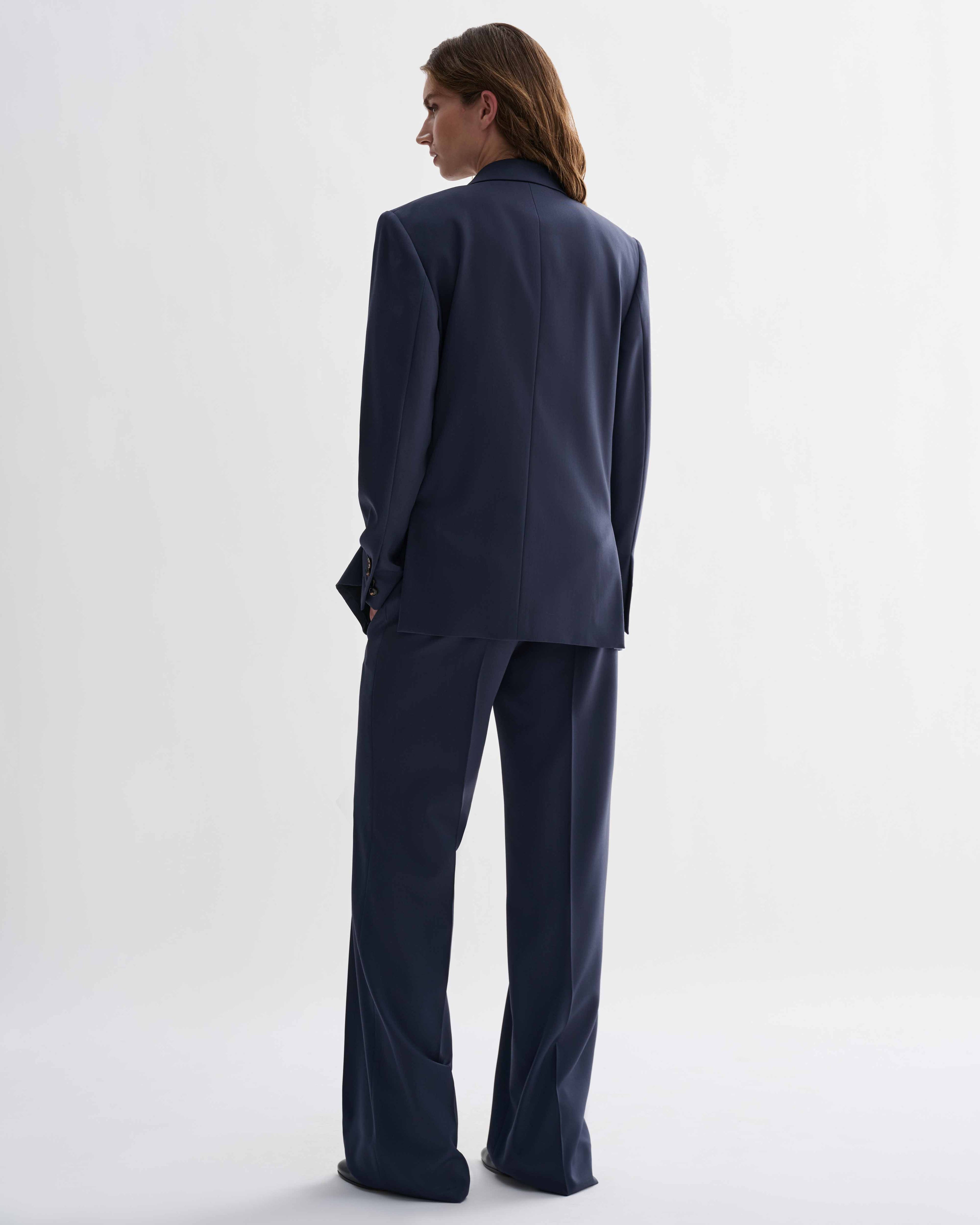 Petrol Blue Roman Double Breasted Jacket and Dylan wool trousers suit. Model wearing precisely tailored menswear, back view