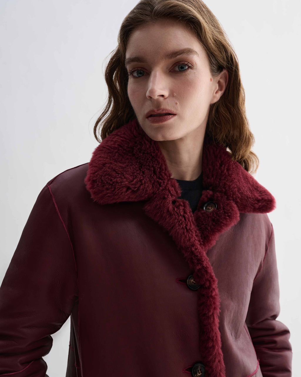 Romy Coat in Bordeaux double-faced shearling. Reversible luxury women's jacket with generous volume