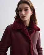 Romy Coat in Bordeaux double-faced shearling. Reversible luxury women's jacket with generous volume