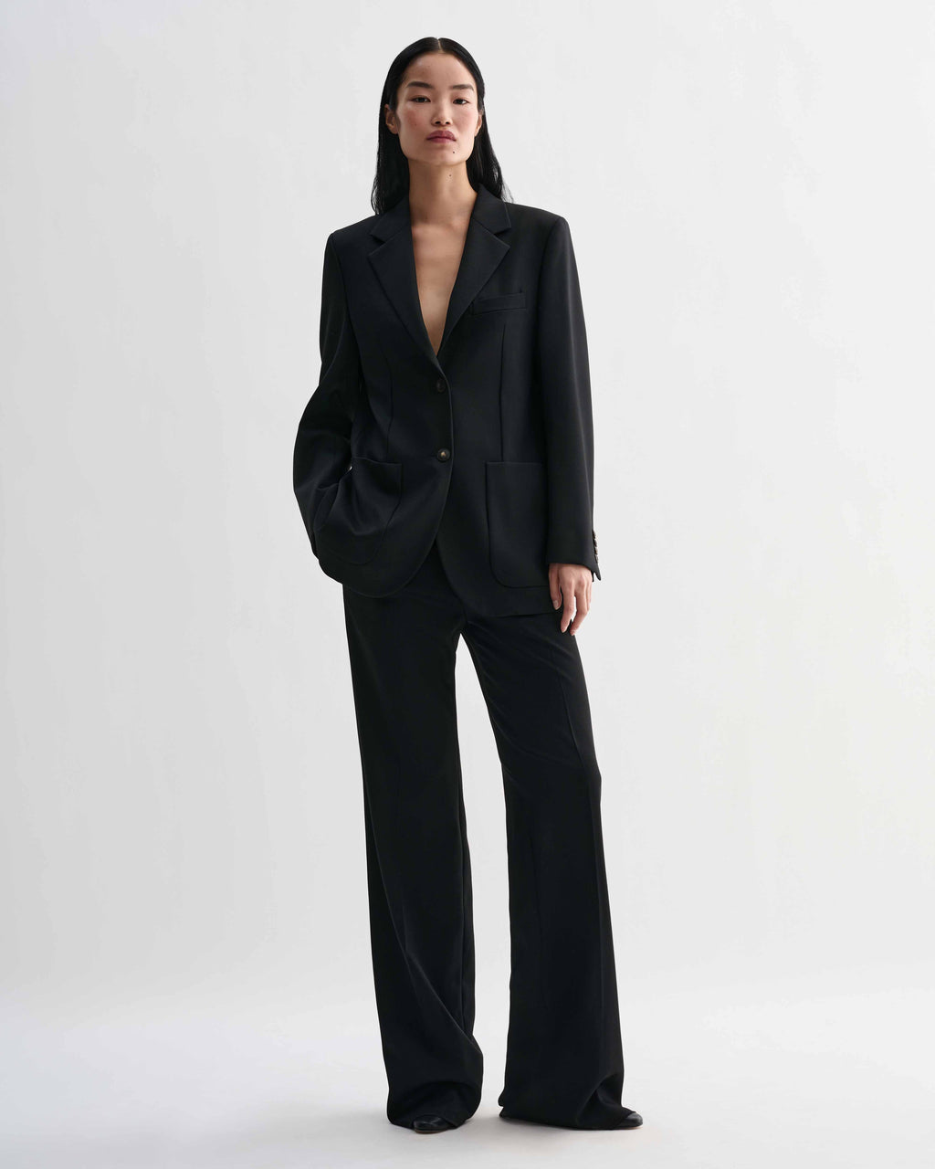 Black Sebastian structured stretch wool twill blazer on model, styled with Taylor trousers forming a luxury straight fit women's suit