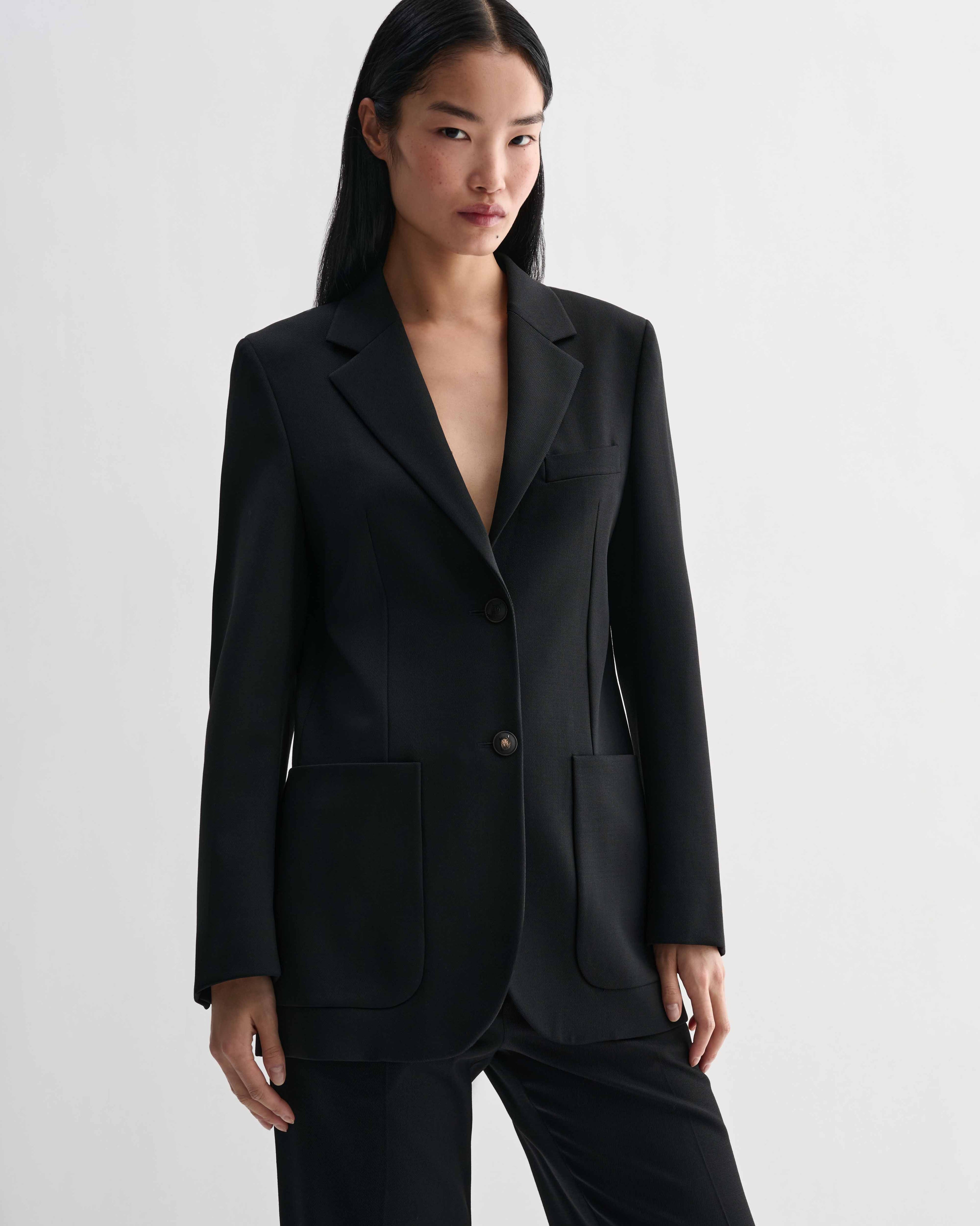 Black Sebastian Jacket blazer in stretch wool twill. Structured, straight fit jacket with single button closure and patch pockets