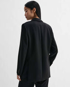 Sebastian black stretch wool twill blazer, structured straight fit with masculine cues, modeled from back view