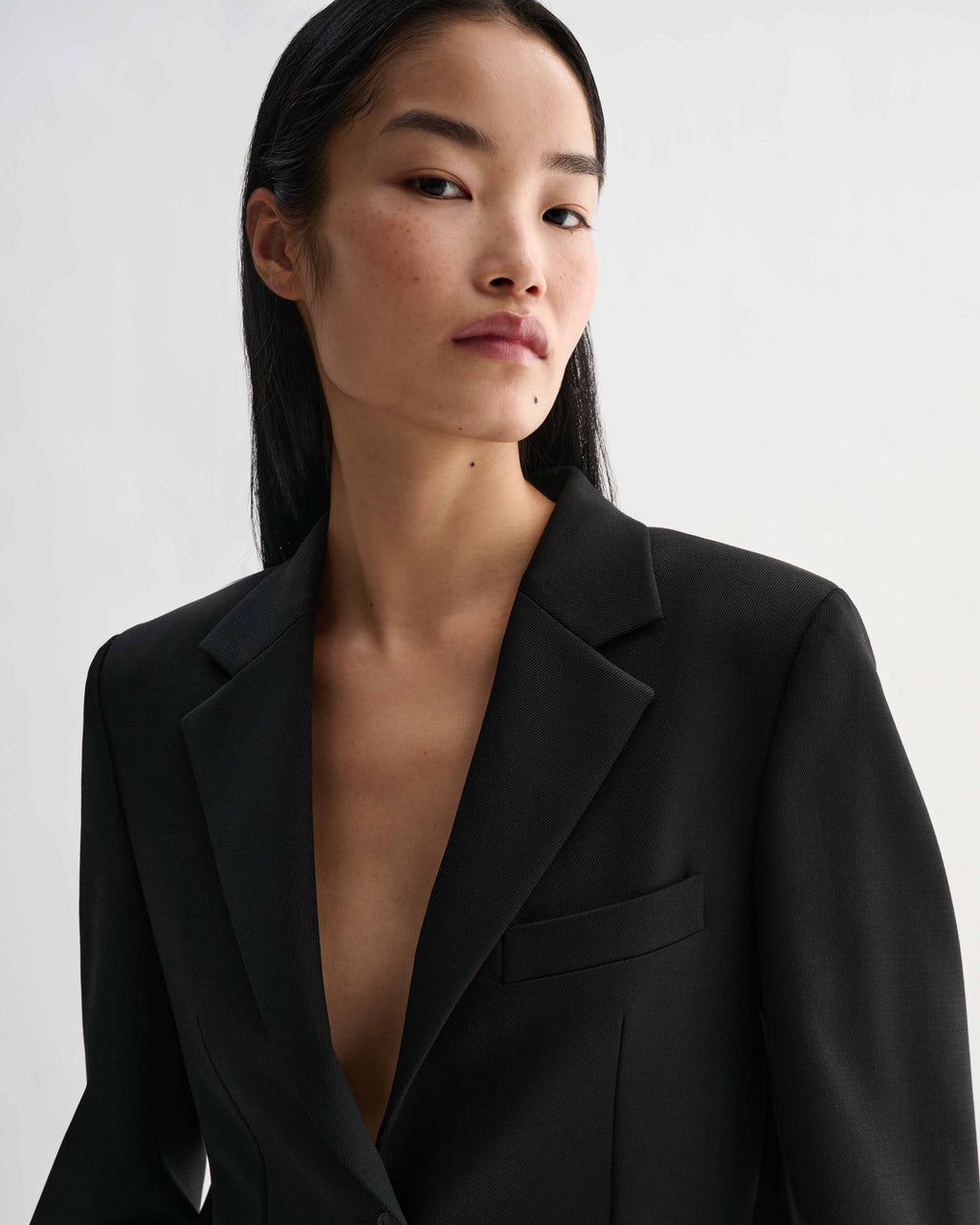 Black Sebastian stretch wool twill blazer on model. Structured, straight fit jacket with modern menswear style