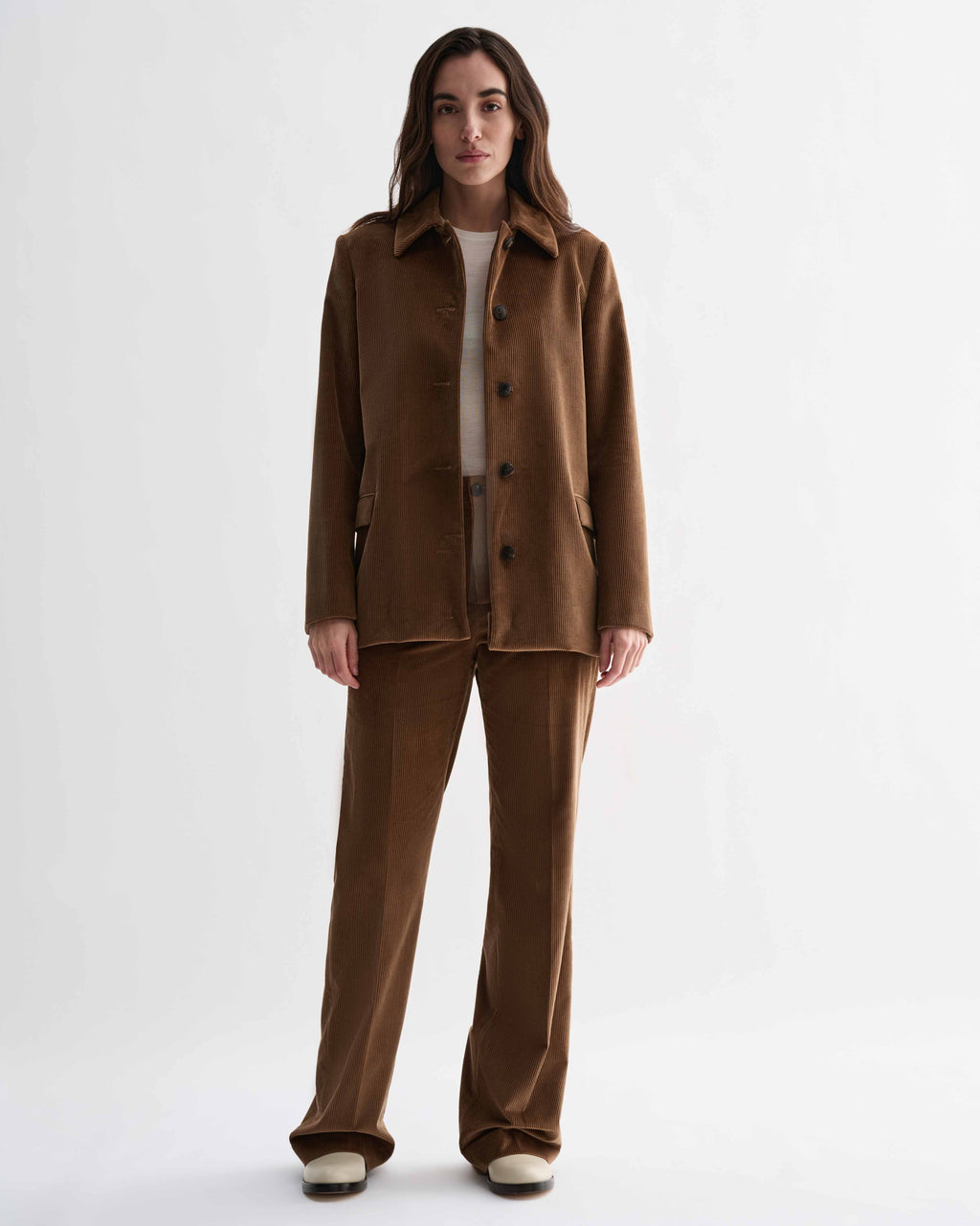 Women's camel corduroy Taylor Trousers. Tailored, thick-wale fabric, straight silhouette bottoms worn with matching suit jacket.
