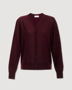 Katie Merino Wool Cardigan in Garnet, deep plum knitwear with a cozy fit and button details, showcased on a model.