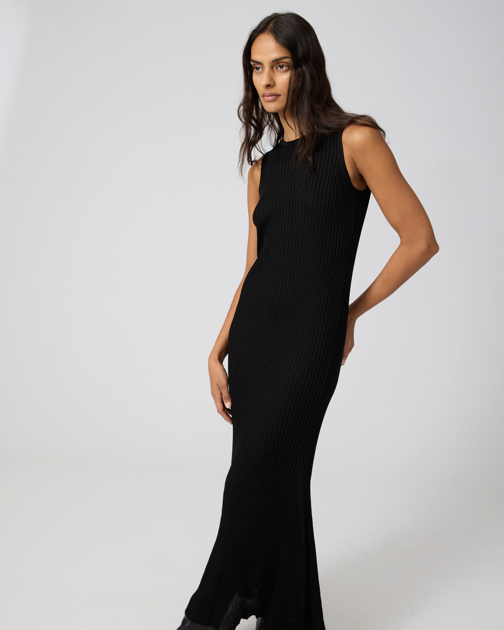 Black Gabby dress by Veronica De Piante in viscose fabric, shown on a hanger with a smooth, flowing silhouette.