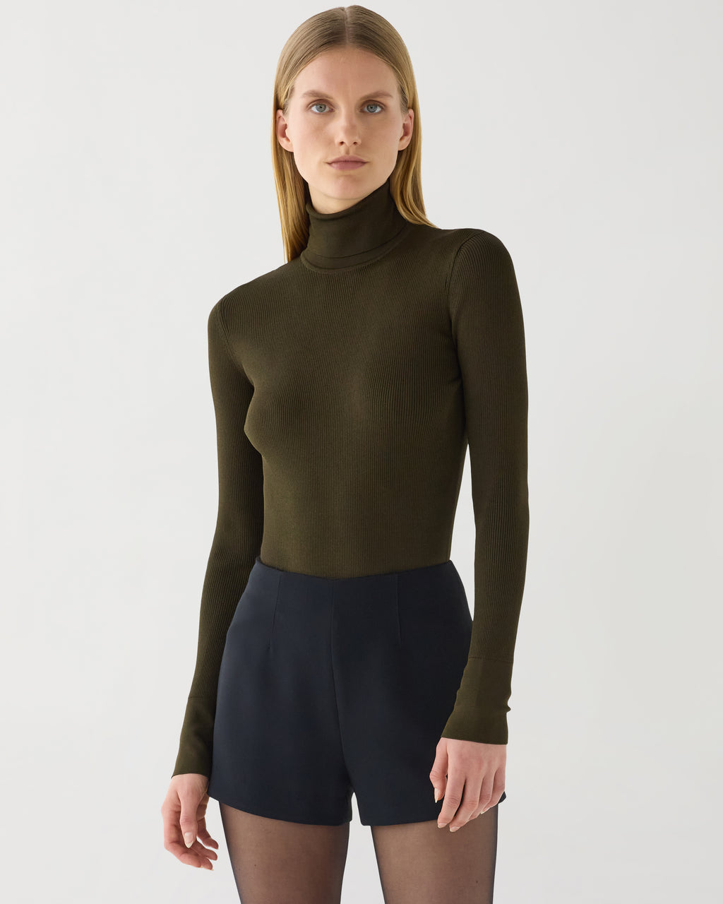 Olive green Evanne turtleneck knitwear in silk crepe by Veronica De Piante, shown on a model.
