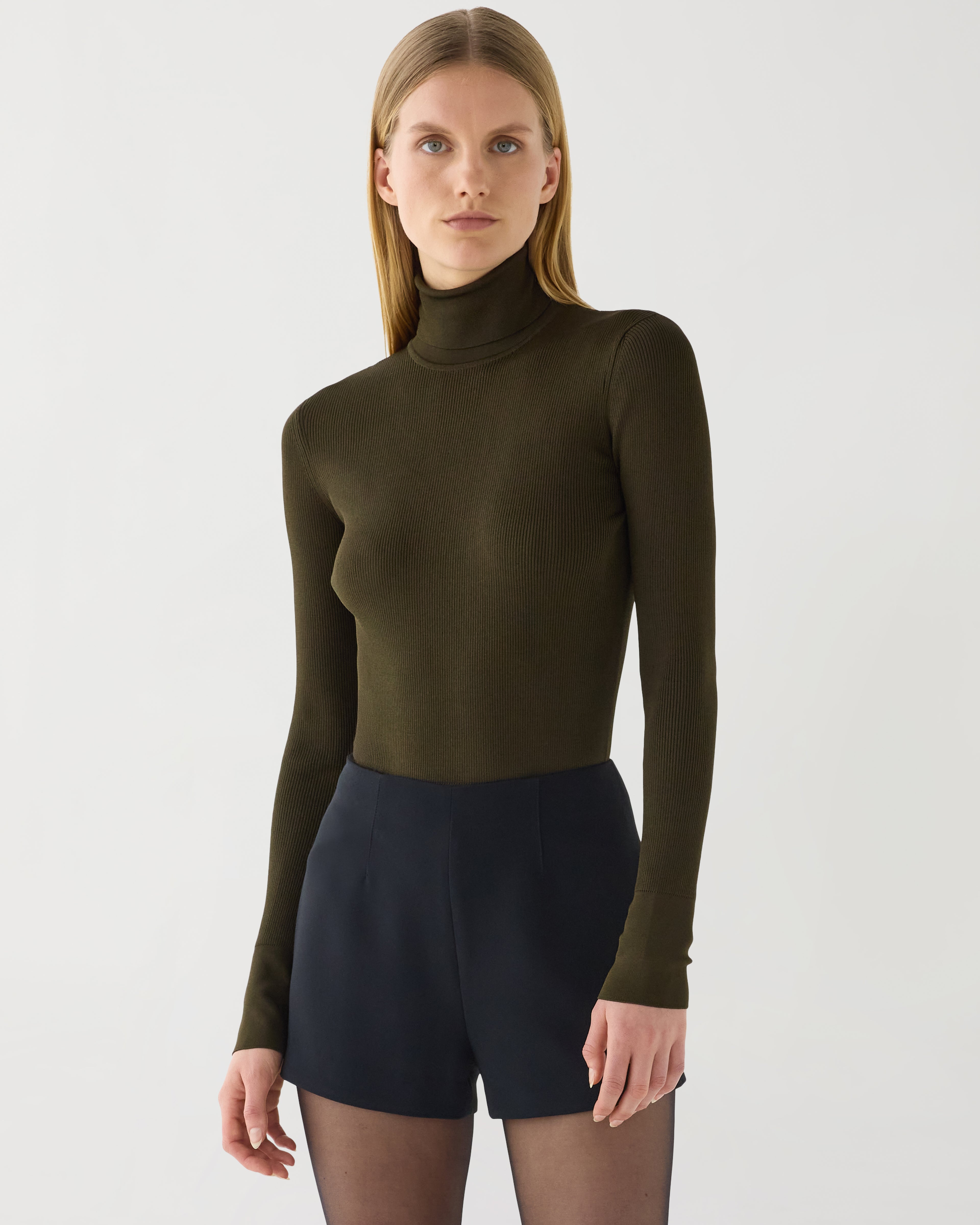 Olive green Evanne turtleneck knitwear in silk crepe by Veronica De Piante, shown on a model.