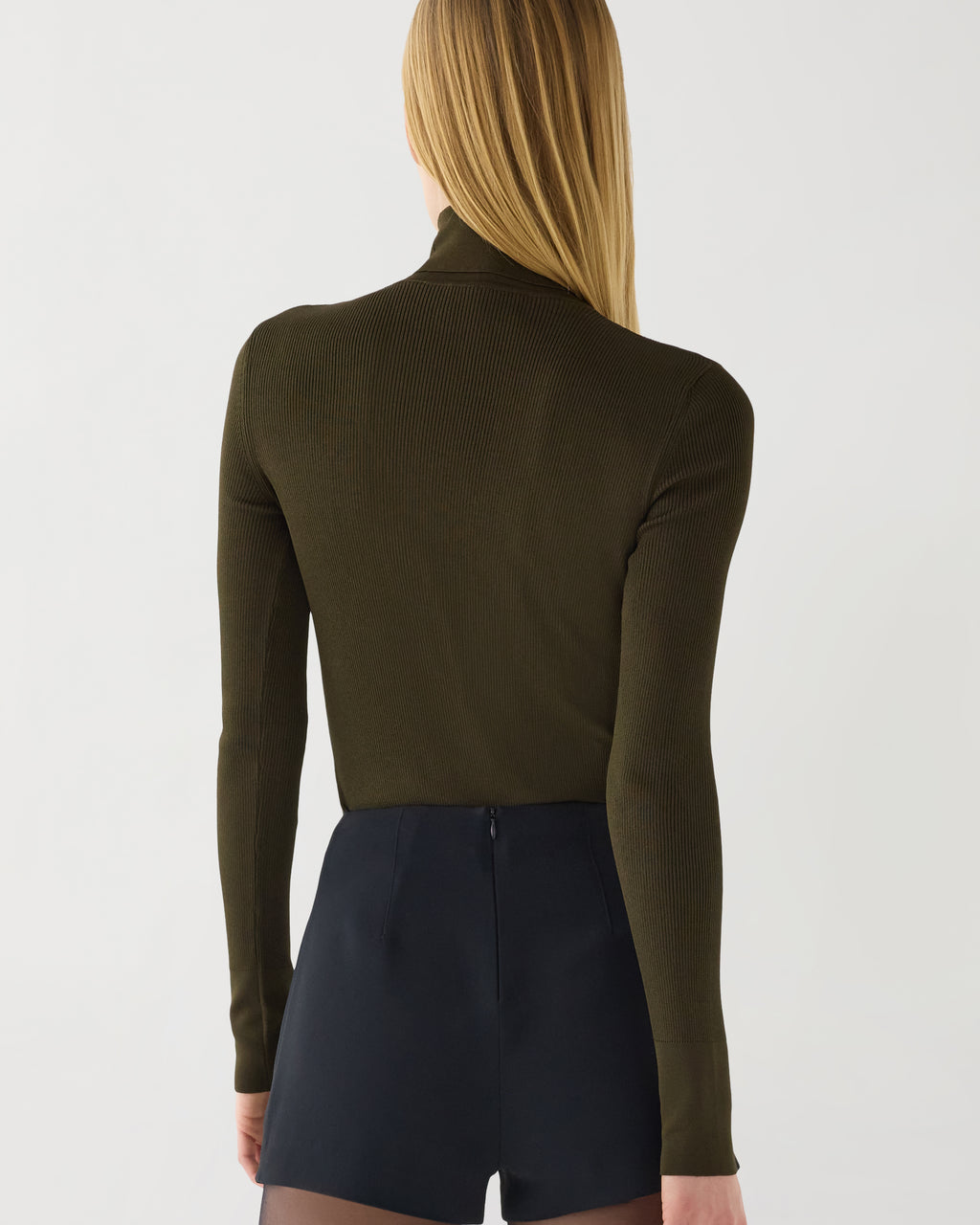 Olive green Evanne silk crepe turtleneck sweater by Veronica De Piante, showcasing its smooth knit texture and fitted style.