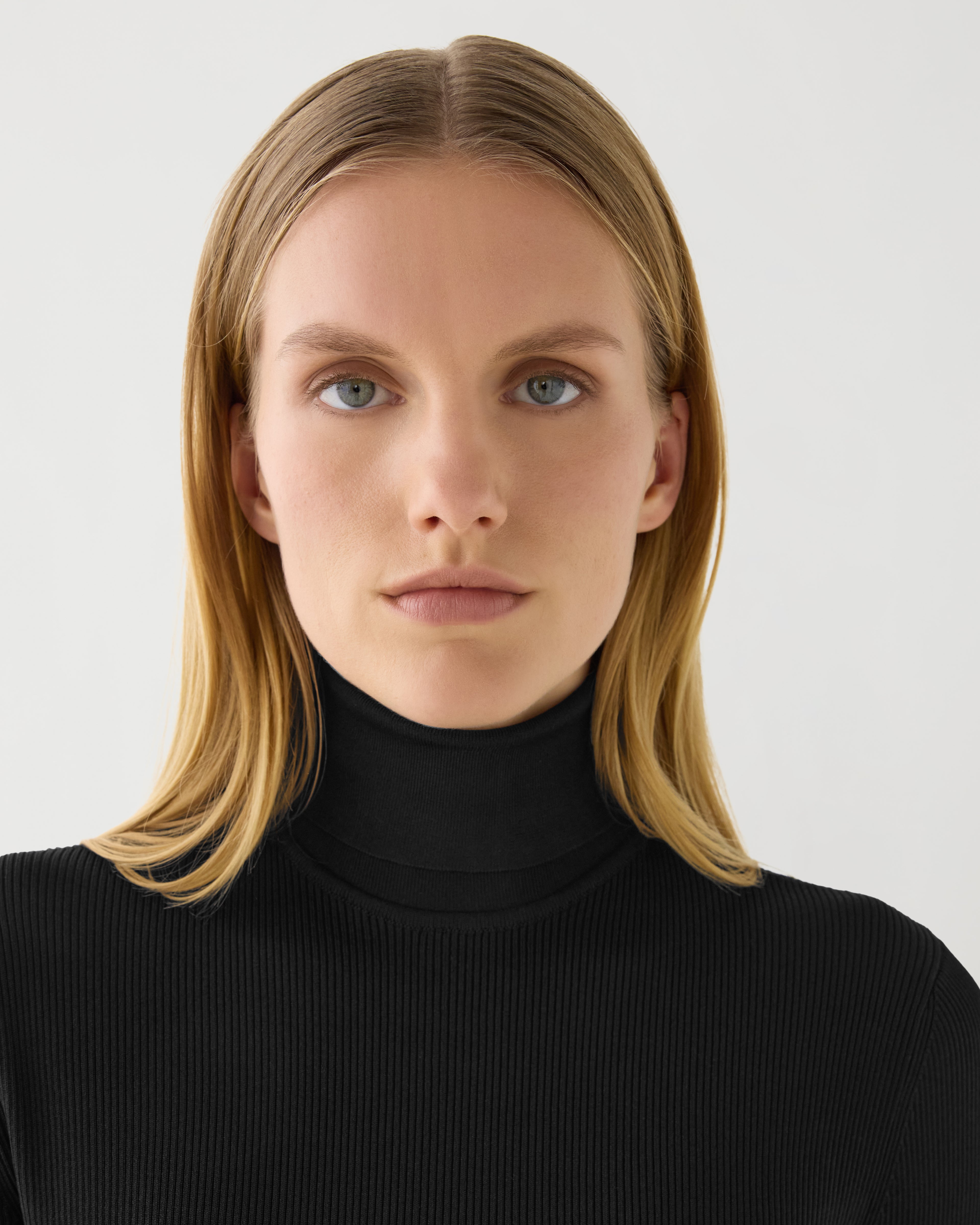 Black silk knit Evanne turtleneck sweater, showcasing a soft texture and fitted design, ideal for stylish layering.
