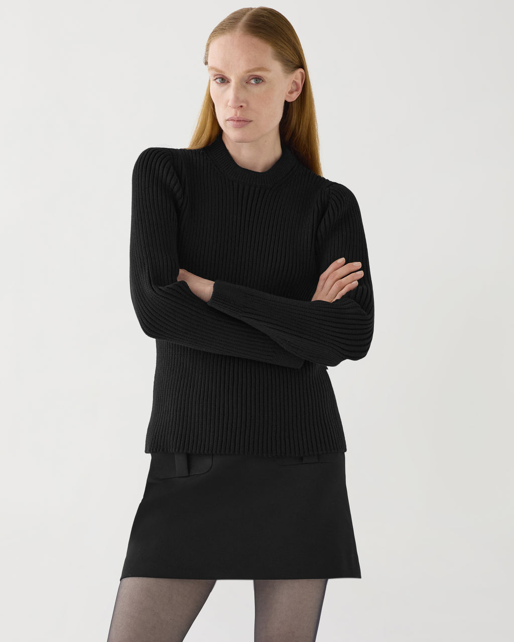 Black Ivy Merino Wool sweater on model. Semi-fitted, ribbed knit, mid-heavy, bulletproof, mock neck, long sleeves. Knitwear