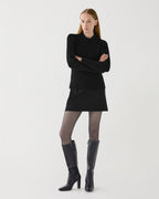 Black Ivy Merino wool ribbed knit sweater on model, semi-fitted with a high neck, luxury knitwear garment