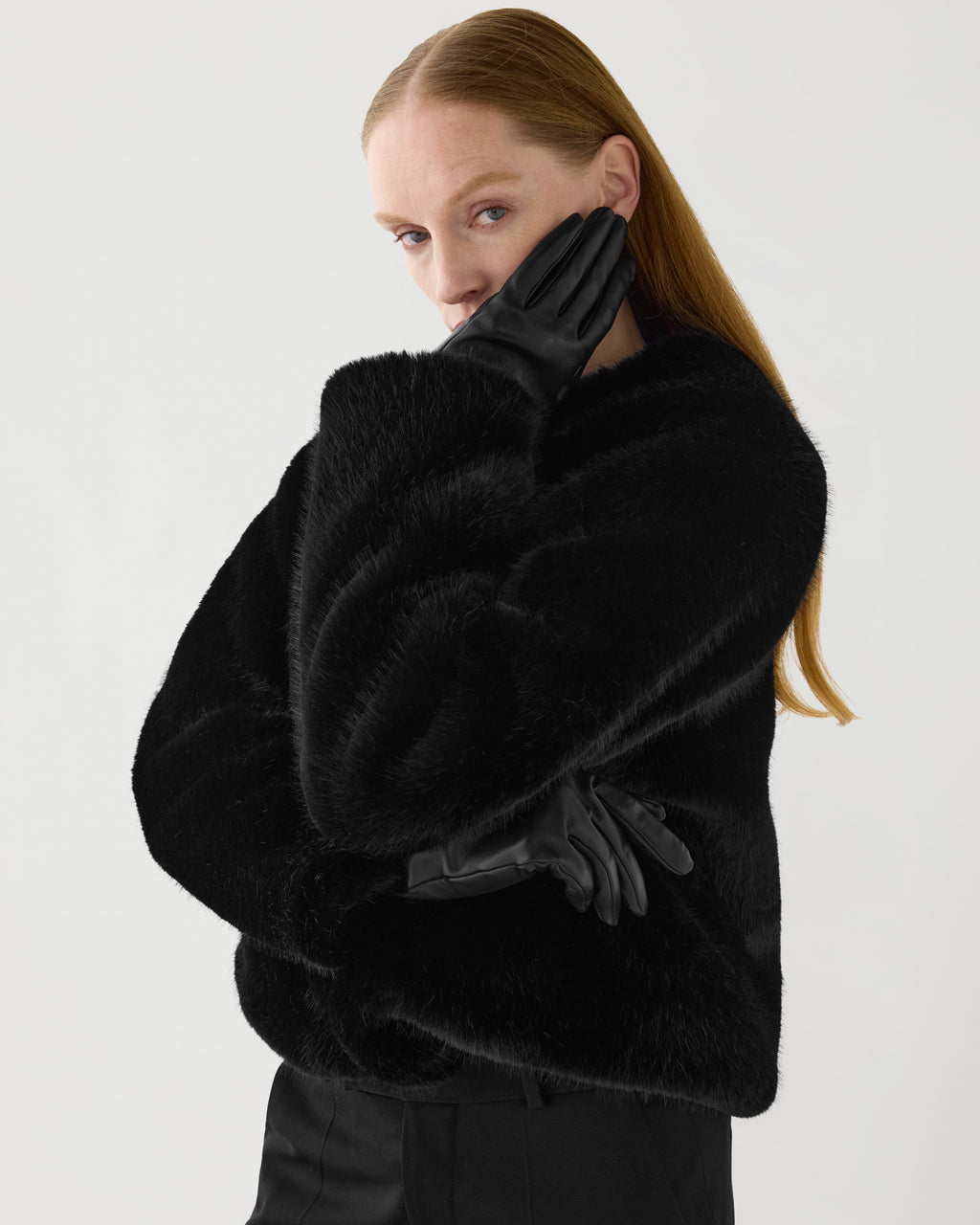 Sadie black cropped faux fur jacket on model. Plush vegan fur coat with a boxy silhouette for modern luxury
