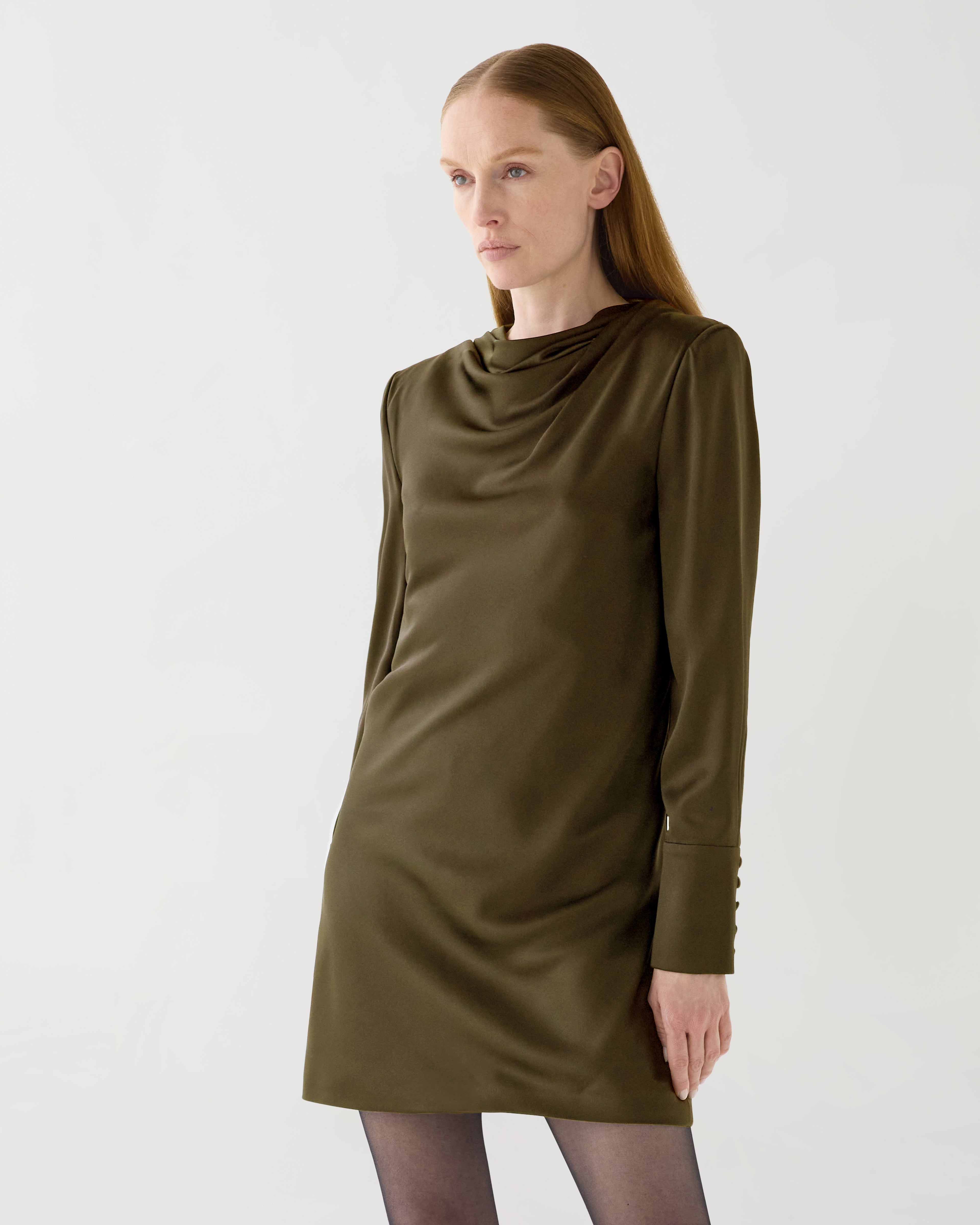Olive green Amal dress in stretch silk by Veronica De Piante, shown on a model with flowing fabric and elegant design.