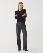 Dark grey plaid Avery trousers displayed on a hanger, showcasing the sleek fabric and tailored fit for stylish bottoms.