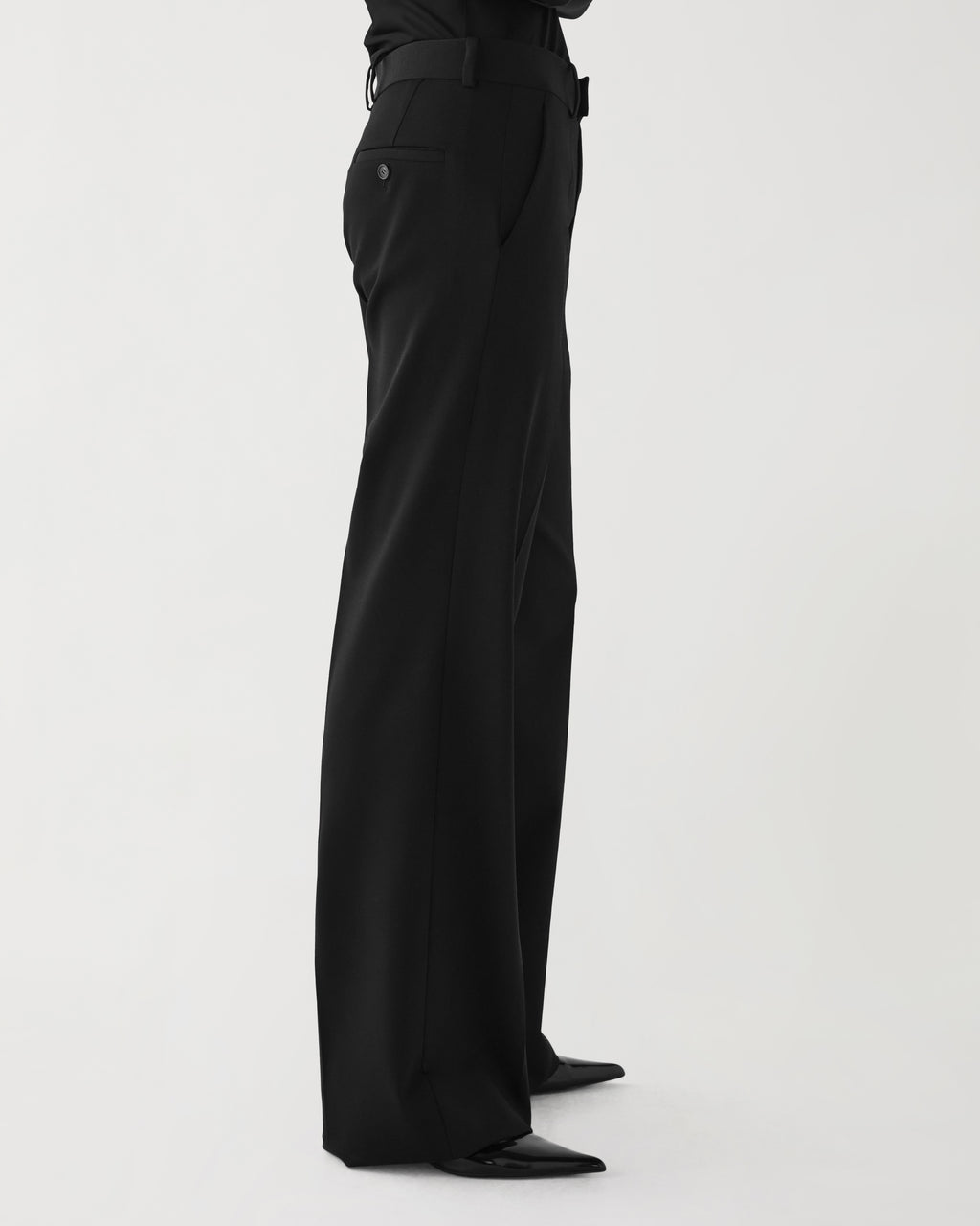 Black Taylor Trouser in stretch wool twill by Veronica De Piante, shown on a hanger with a tailored fit and sleek design.