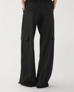 Black Etta trousers by Veronica De Piante in Grain de Poudre wool, showing tailored fit and textured fabric.
