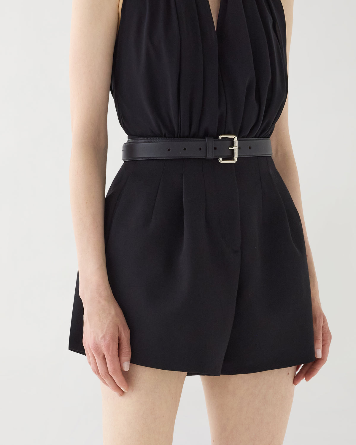 Black Tilly high-waist Grain de Poudre wool shorts with front pleats, tailored silhouette, black belt, silver buckle